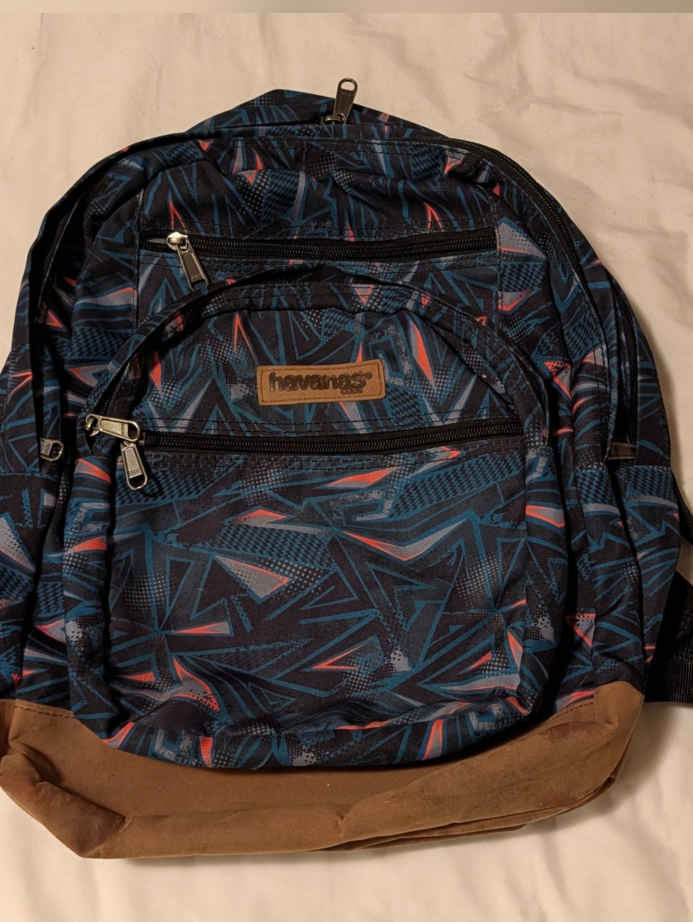 Havaianas Men's Navy Geometric Backpack with Coral Accents and Brown Suede Base